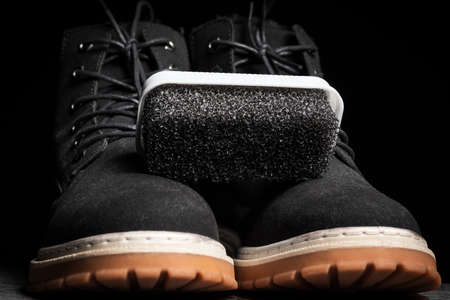 Black foam sponge for suede shoes with black boots.の写真素材