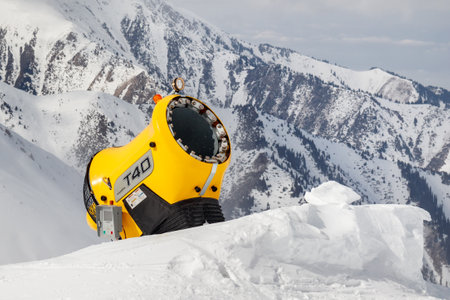 Almaty, Kazakhstan - March 16, 2021: Snow cannon against the rocky mountain slope. Snow making machine on ski slopesのeditorial素材