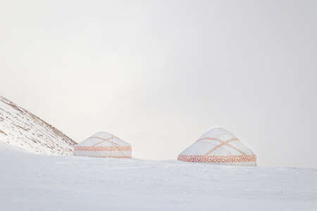 White yurts with kazakh ornament in the snowy mountains of central asia.の写真素材