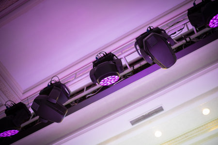 Light heads beam and fill hang on a truss above the ceiling in event hall.の写真素材