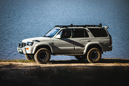 Japanese offroad used white car Toyota Hilux Surf on the lake. Almaty, Kazakhstan - September 28,...