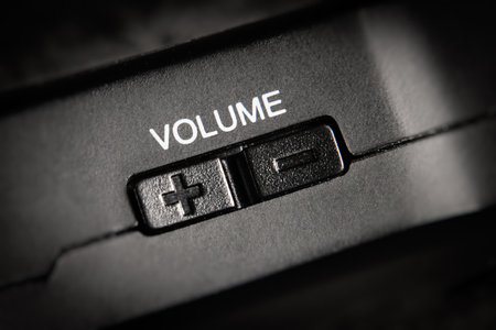 Macro Of black Volume Buttons rocker Of A black handy audio device.の写真素材