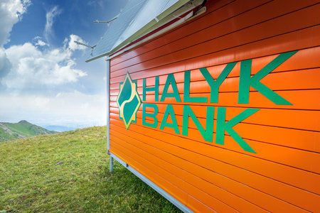 Halyk bank logo on self-contained rescue hut with solar panels for hikers on top of Almaty mountains. Almaty, Kazakhstan - July 19, 2022のeditorial素材