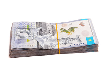 Side view of Bundle of Kazakhstan banknotes of 20000 tenge tied with an elastic band, isolated on...