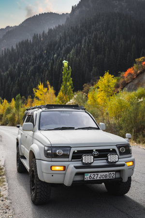 Off-road white car Toyota on autumn mountain road trip. Almaty, Kazakhstan - September 28, 2022のeditorial素材