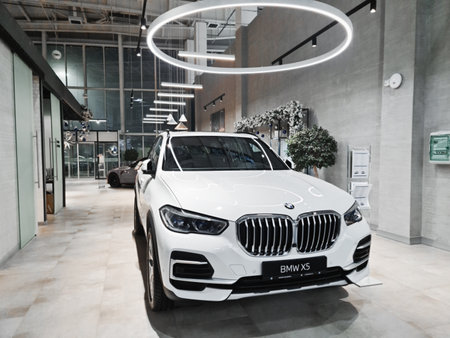 New white german car BMW X5 with nimbus in a car dealership. Almaty, Kazakhstan - December 30, 2022.のeditorial素材