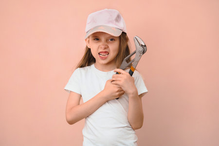 When dad wanted a son, but he is raising a daughter. Girl tomboy with a wrench.の写真素材