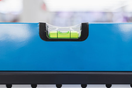 New blue building level in packaging on a shelf in a store, close-up.