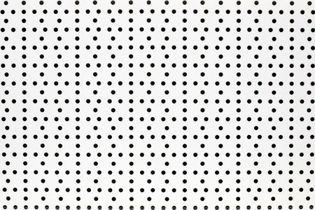 Background of white perforated white painted metal sheet.の写真素材