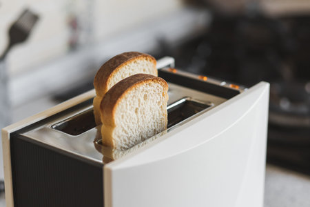 Modern toaster ready to toast white bread for a delicious breakfast.の写真素材