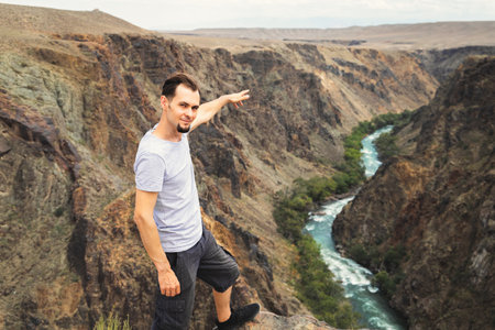 Man travels through the national parks of Central Asia, he points to the Charyn River in Kazakhstan.の写真素材