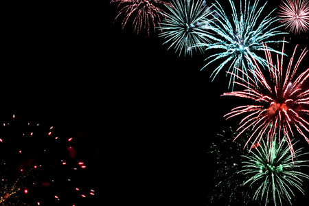 Festive black background for new year design with real fireworks and sparks, copy space.