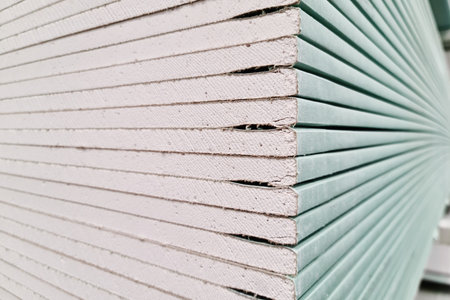 Drywall stacked in stacks at a hardware store, close up.の写真素材