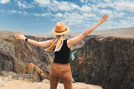 A woman tourist delighted with upper part of the Charyn River, which flows through the Charyn Canyon in Kazakhstan in the Almaty region.の写真素材