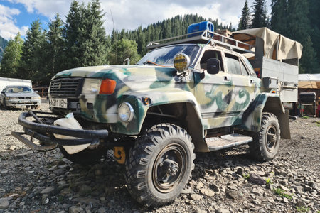 Camouflage tuned volga GAZ 3110 car customized as a monster truck on huge off-road wheels. Almaty,...