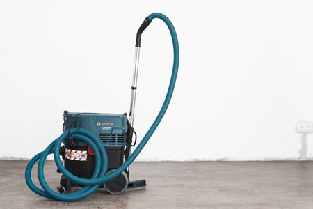 Professional construction vacuum cleaner in an empty room with white walls. Almaty, Kazakhstan - Marth 18, 2023のeditorial素材