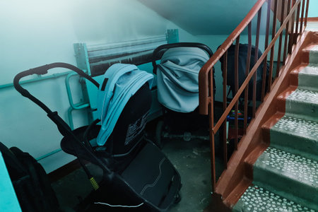 Storing baby strollers in the entrance of an apartment building.