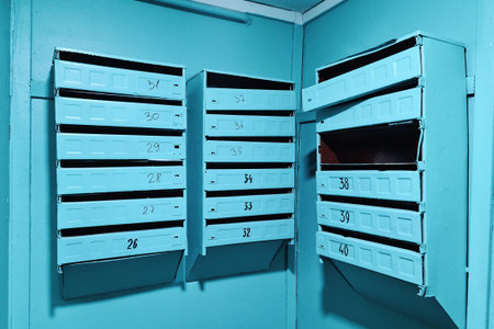Mailboxes in the entrance of an old ussr house with some broken doors.