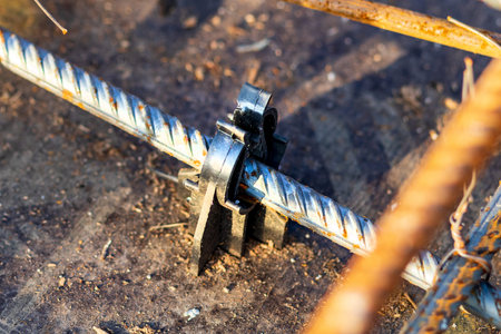 Black plastic reinforcing bar supports are used as accessories for formwork in the construction of...
