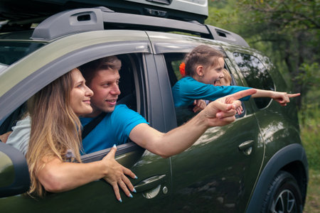 A happy family enjoys a beautiful nature view from their car during a joyful outdoor adventure togetherの写真素材