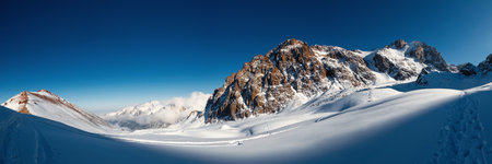 Scenic panoramic view of breathtaking high-altitude mountains in Central Asia. Experience winter expedition through the majestic Tien Shan range, Mountains of Kazakhstan national natural park.の写真素材
