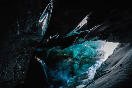 Ice cave: Entrance Near Bogdanovich Glacier, Tian Shan Mountains, Central Asia, Almaty, Kazakhstans National Park, Zailiysky Alatau Natural Wonders.の写真素材
