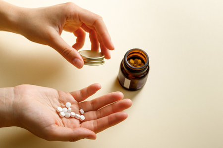 How to choose the right dosage of a medication. Handful of pills in patients hand at home.の写真素材
