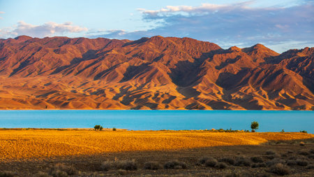 Amazingly picturesque morning landscape of Tien Shan red mountains and Lake Bartogay, Nature of Kazakhstan near Almaty.の写真素材