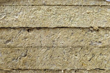 Close-up of stacked rock wool thermal insulation slabs, showing the fibrous texture of energy-saving...