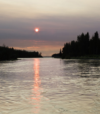 Forest fire smoke makes Sun red, and all around is different due to large amounts of smoke..の写真素材