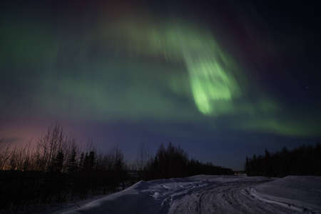 Active green-pink display of Aurora Borealis in Alaskaの写真素材