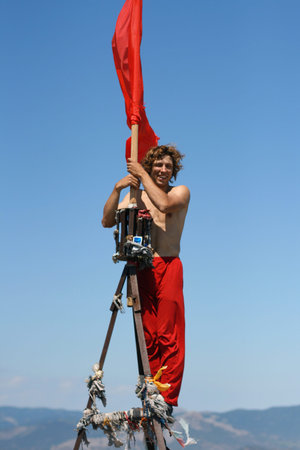Guy in red trousers on the mountain top