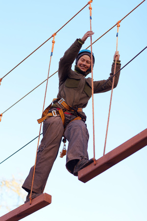Happy woman enjoying activity in a  rope parkの写真素材