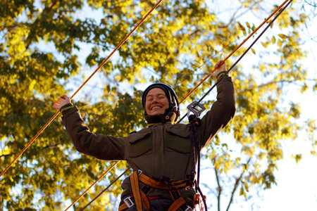 Happy woman enjoying activity in a  rope park