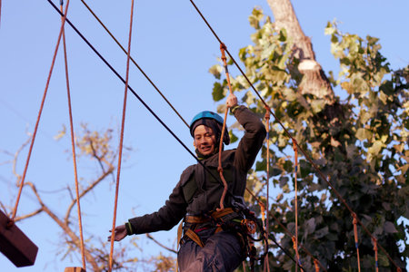 Happy woman enjoying activity in a  rope park