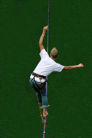 Fearless highliner walking on tight ropeの写真素材