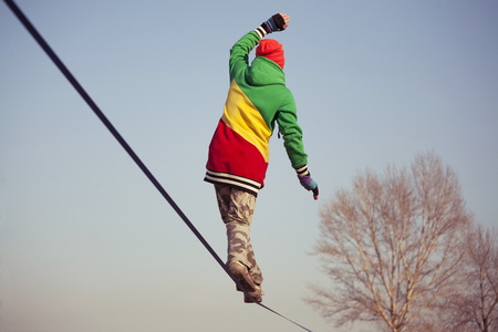 Man balancing on slackline in the parkの写真素材