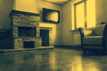 Toned in yellow hue interior with fireplaceのeditorial素材