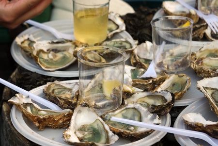 Fresh oysters and white wine on french marketの写真素材