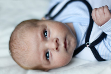 Adorable newborn baby boy with blue eyes