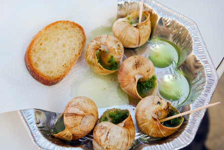 snails as gourmet food with bread on french farmer marketの写真素材