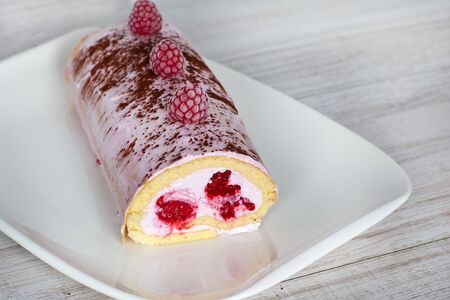 Swiss roll biscuit with red raspberriesの写真素材