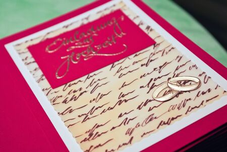 Selfmade wedding invitation cards in red and goldの写真素材