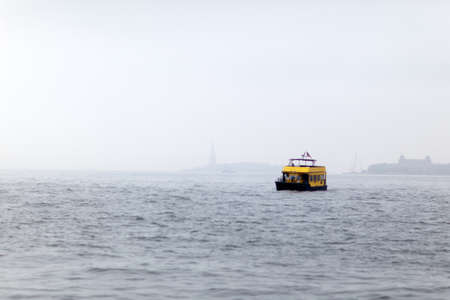 Staten Island Ferry (public transportation) leaving from Battery Park in New York on foggy dayの写真素材
