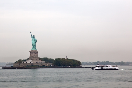 Statue of Liberty and ferry cruises  public transportation , New York on day with fogのeditorial素材