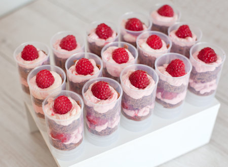 Push up cake pop with raspberry  cream and chocolate bisquit on stand