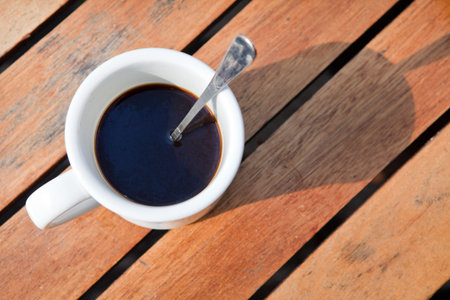 White coffee cup against wooden background
