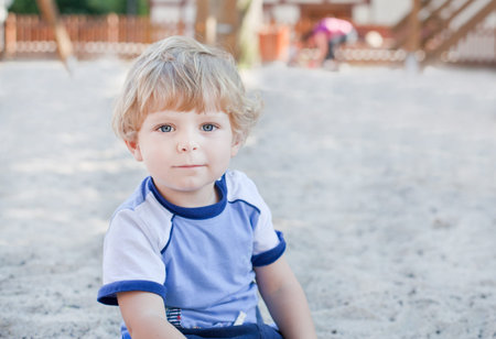 Portrait of adorable little toddler on summer playgroundの写真素材
