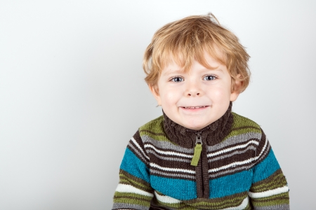 Portrati of adorable toddler with blue eyes and blond hair with white backgroundの写真素材