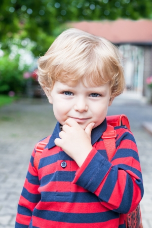 Little toddler boy on way to kindergarten outdoorの写真素材